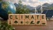 © TransPicHub - A conceptual image on climate change, with wooden blocks, a globe, and renewable energy sources like wind turbines and a solar panel in a natural setting.