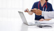 © groviapoto - Medical Team Discussing Patient Case looking at Laptop Screen, Senior Doctor and Nurse Pointing at Computer, Healthcare Practitioners Collaborating in Clinic Office or Hospital Boardroom