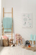 © New Africa - Different toys, small chairs, picture and wooden ladder in child's room