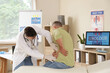 © Pixel-Shot - Young urologist examining mature man on couch in clinic