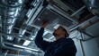 © MHS - Professional hvac technician inspecting a ceilingmounted air conditioning unit in an industrial facility