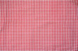 © Jenifoto - Red and white check table cloth background. Top view. Copy space. Summer outdoor food or picnic theme.