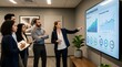 © Salim - Business team looking at performance data charts on a large wall screen during a meeting in a modern office setting