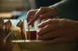 © Bits and Splits - Close-up of female hands browsing old card catalog drawers, vintage library research concept