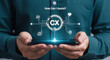 © DA_STOCK - Customer experience CX digital interface on smartphone, businessman holding mobile phone with virtual service icons, customer support concept