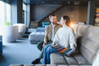 © Serhii - Couple choosing sofa fabric samples in furniture store showroom