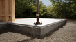 © A2Z AI  - Minimalist Outdoor Foundation with White Slab, Concrete Base, Gravel, and Wood Structure Against Green Trees on a Sunny Day