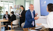 © JackF - Elderly male bank manager shakes hand with adult woman client during business meeting