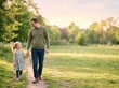 © Pink Zebra - Fatherhood bond. Father and young daughter walking hand in hand on a trail, Father's Day celebration, portraying a loving family relationship and outdoor lifestyle.