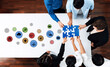 © InfiniteFlow - A group of diverse professionals collaborates in a modern workspace, solving a puzzle together while engaging with various business icons representing creativity and innovation. Trope
