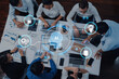 © InfiniteFlow - A diverse group of business professionals collaborates in a modern office setting, utilizing AI technology and data visualization to enhance their strategic discussions. Trope