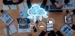 © InfiniteFlow - A diverse business team engages in a collaborative discussion focused on cloud computing strategies and data analysis in a contemporary office setting. Trope