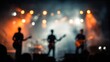 © Selvi - Blurred background of an open-air concert stage with silhouetted musicians performing under vibrant lights