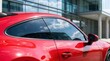 © Masque - Red car with automotive window tinting for improved comfort and UV protection.