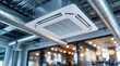 © Masque - Sleek air conditioning unit installed in a modern office with exposed ductwork design elements.