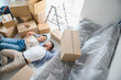 © Serhii - Young couple relaxing on floor in new home