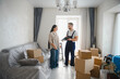 © Serhii - Moving service worker discussing paperwork with customer