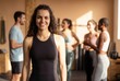 © Asier - Woman smiling at camera with a group of diverse friends after a workout session