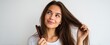 © Yr - Happy Woman with Long Smooth Hair Using Hairbrush