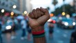 © Fadil - Raised Fist with Pan-African Flag Wristband at Protest