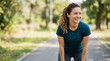 © Xenia - Smiling young woman resting after outdoor workout in park. Healthy lifestyle and fitness concept