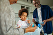 © Marko Geber - Family recycling plastic bottles in home kitchen