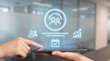 © SYATRI RAWU - Future of business Hands interact with a tablet displaying holographic icons for team, planning, and analytics