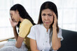 © Wasan - Upset Asian mother and daughter having family conflict, experiencing relationship problems, stress, and communication breakdown after an argument, showing disappointment and sadness.