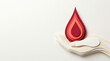 © Len_mik - Red blood drop held by a paper cut hand on neutral background for World Blood Donor Day, health campaigns, awareness initiatives, and charity projects