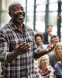 © Justlight - Confident public policy speaker making openhanded gestures engaging a diverse small community in a modern town hall with natural window light and blurred attentive attendees in the