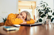 © baranq - Tired woman napping at desk with laptop at home