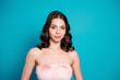 © deagreez - Young woman portrait smiling confidently in a strapless summer dress against a bright blue background, beauty and fashion concept with elegant makeup and wavy hair