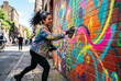 © BlackBridge Media - Street Artist Creating Colorful Mural on Urban Brick Wall