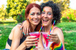 © AlvaroRT - Lesbian couple celebrating pride with rainbow makeup and cocktails