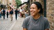 © Marlon - Smiling woman with dreadlocks on a bustling city street with blurred background