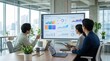 © ShortFilmStock - Colleagues reviewing quarterly performance charts and financial statistics on large display in glass conference room