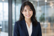 © maaagram - オフィスで微笑むスーツ姿の女性社員 Generative AI