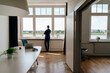© Westend61 - Businesswoman standing in modern office looking out of window