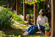 © olezzo - Mature woman sitting on a terrace with her eyes closed, enjoying the warm sun on her face on a beautiful summer day.