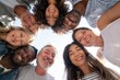 © Studio Nova - The group of diverse smiling friends forming a circle and looking down together