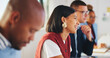© peopleimages.com - Woman, business and smile in meeting for learning, workshop and creative opportunity in agency. Attention, employee and colleagues in office for training forum, project feedback and collaboration
