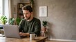 © Eve - Focused young Caucasian man with beard working on laptop at desk, serious male remote freelancer typing on computer in home office, entrepreneur studying online education.