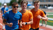 © Maksym - Blind runner and sighted guide athlete training on track together during inclusive athletics program, tethered at wrist, stride perfectly synchronized, coach with stopwatch timing them from infield,