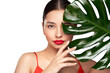 © Oleg Gekman - Close up woman face with green exotic leaf. Skin care beauty treatments concept. Model with clean, health skin of face. Monstera Leaves