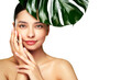© Oleg Gekman - Close up woman face with green exotic leaf. Skin care beauty treatments concept. Model with clean, health skin of face. Monstera Leaves