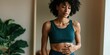 © Andrii Zastrozhnov - Young fit woman in teal sports bra gently touching her stomach indoor wellness portrait for health and lifestyle background and fitness banner