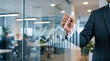 © DANG QUANG - Male executive drawing a glowing financial growth chart on a clear glass partition in a contemporary office environment.