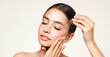 © Oleg Gekman - Young beautiful woman applying face serum with pipette. Cosmetic procedures for facial skin care