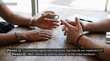 © Muhammad - Two people holding hands in supportive conversation with warm natural lighting