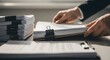© Natsumae - Hands sorting through a large stack of office documents